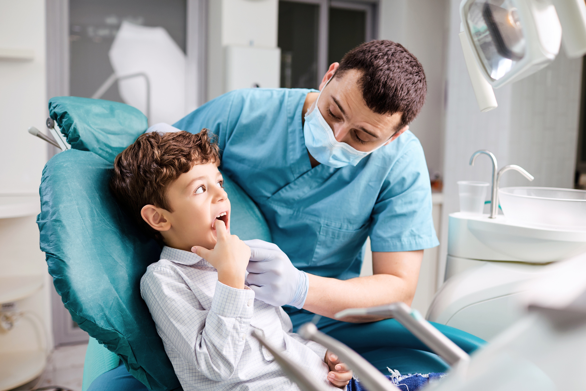 Dentist Checks the Child's Teeth