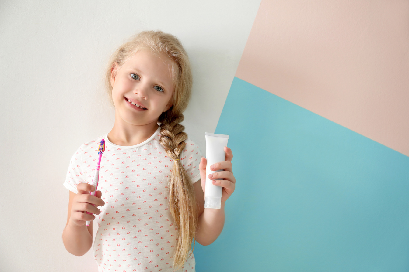 Girl Holding a Toothbrush and Toothpaste